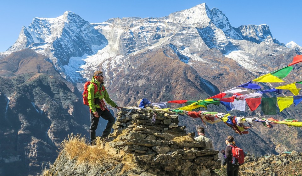 Trekker by the flags at Namche Bazaar view point, Nepal