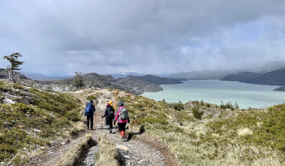 Hikers hiking by Laguna Grey on W trek in Torres Del Paine