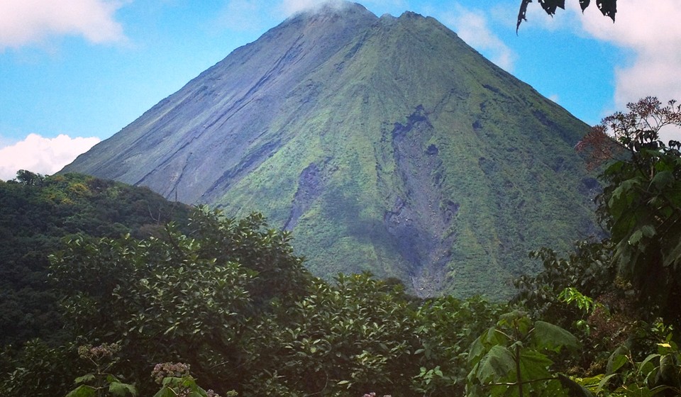 Arenal Volcano with a forest in the foreground