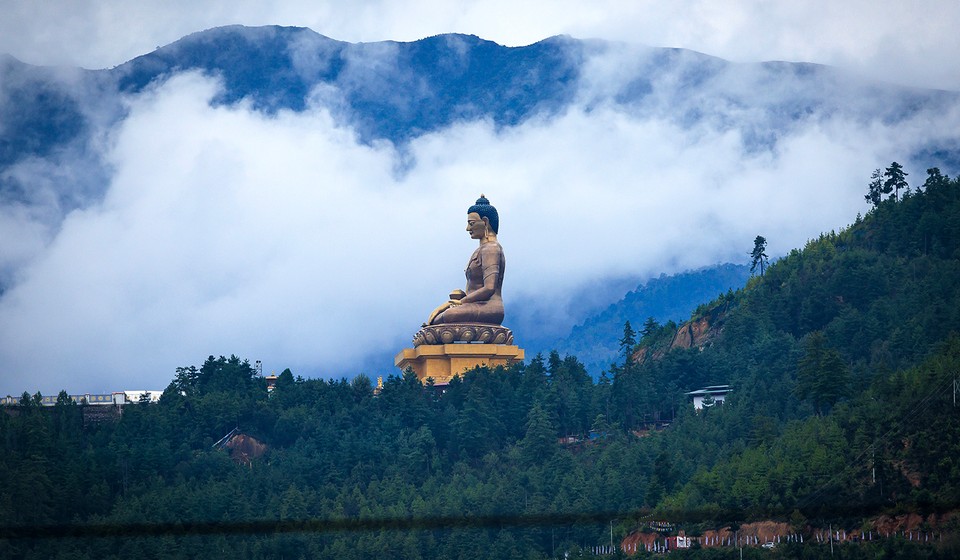 The majestic one of the largest Buddha statue, sitting serenely atop a forested hill in Thimphu, Bhutan.