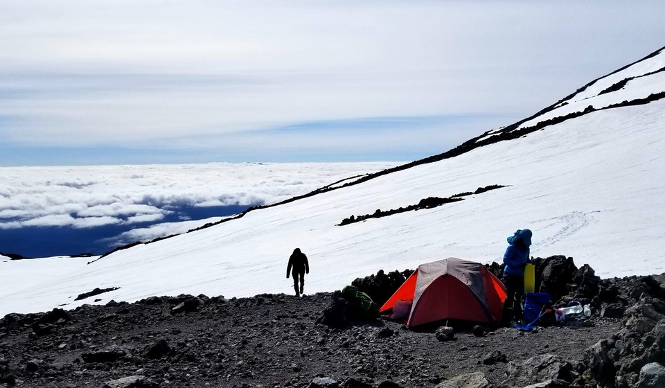 Lone hiker by his tent at the Mt. Adams base camp