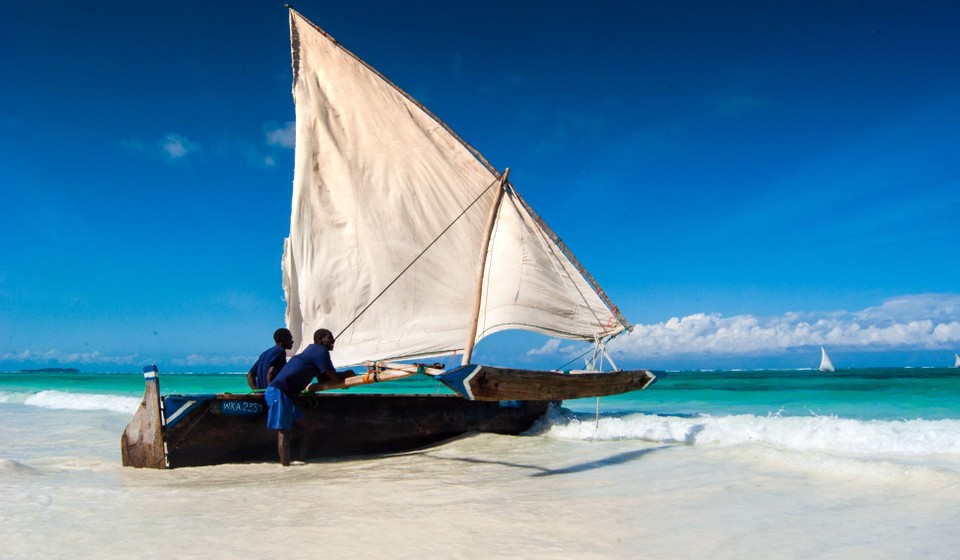 This is the beach off Matemwe in Zanzibar, just as exotic as it sounds with it's talcum powder like coral sand. The sailing boat is locally built. You can see the breakers over the coral reef on the horizon.