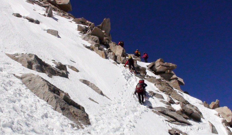 Climbers roped up on a steep section on Mt Whitney mountaineers route on a winter climb