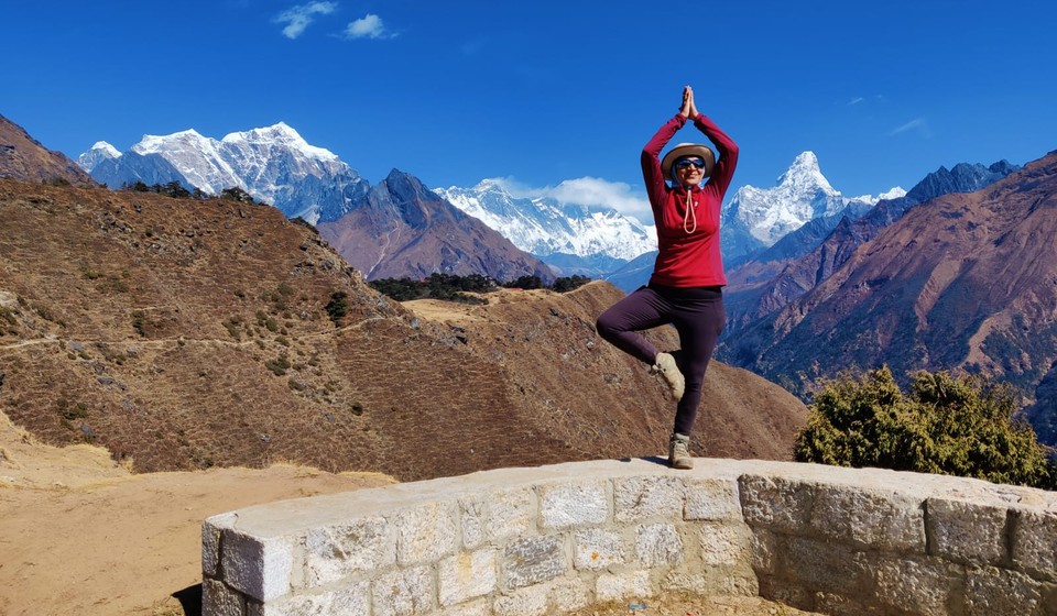 A trekker on the Everest Base Camp Trek doing the mountain yoga pose