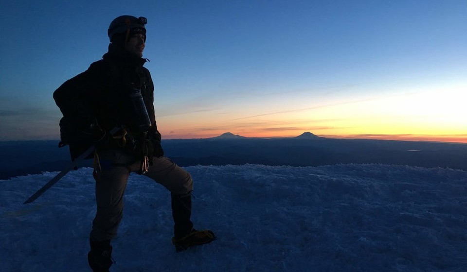 Mountaineer on the summit of Mt Hood at dawn