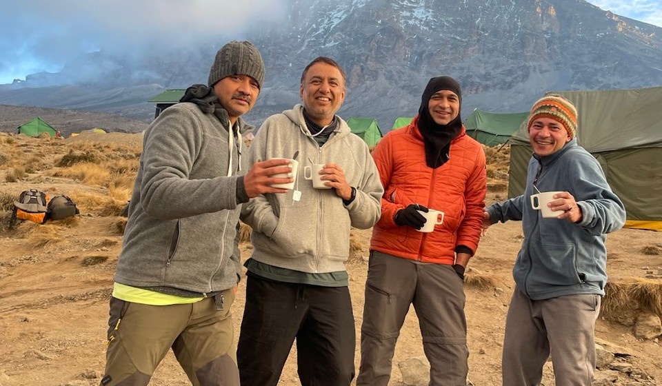 Climbers enjoying a hot beverage on the Kilimanjaro trip.