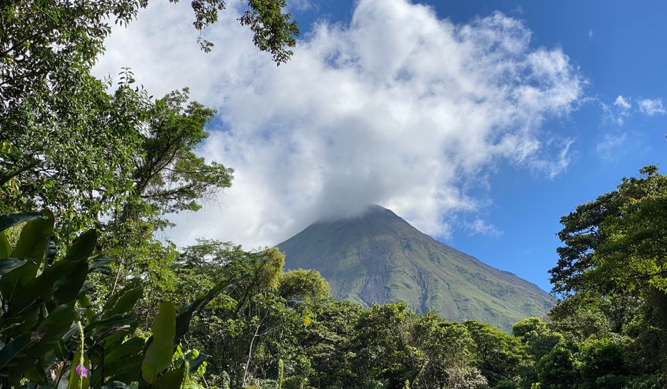 Arenal Volcano with a forest in the foreground