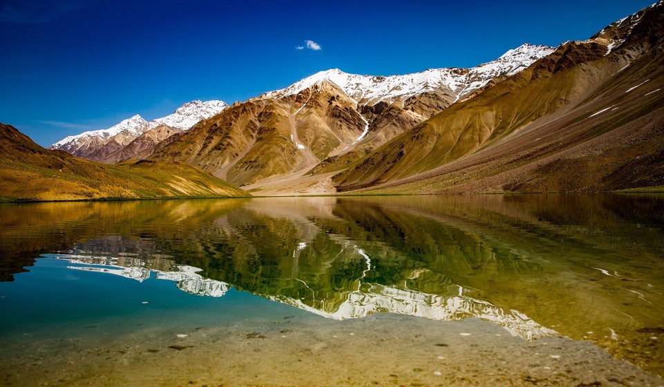 Crescent shaped Chandratal Lake, a popular trekking destination in Spiti Valley in Himachal Pradesh, India. 